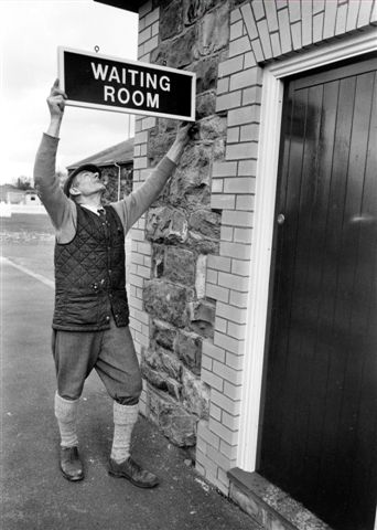 John Keylock erects the Waiting Room sign